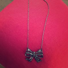 This Is A Lovely Black And White Rhinestone Bow Necklace Never Worn Formal Black Jeweled Necklaces, Glamorous Black Necklace For Gifting, Glamorous Black Necklace For Gift, Formal Black Jeweled Necklace, Black Rhinestone Necklaces For Party, Black Rhinestone Necklace For Party, Black Rhinestone Party Necklace, Black Jeweled Jewelry As Gift, Silver Jewelry With Black Ribbon For Parties