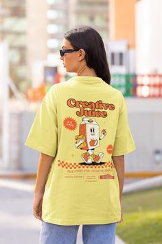 Creative Juice Retro Tshirt, Juice Box, 90s Nostalgia Shirt with a 2 Part Design on the Front and Back. Order a size or two up for an oversized look. We Offer Free UK Delivery! NOTE TO OUR CUSTOMERS We are a new business and very much appreciate your support! If you love your Tee as much as we hope you do, please leave us a review, thank you in advance- stay cosy and stay groovy! 💚 HOW TO ORDER 💚 1. Check our photos for sizing and colour options. 📏 2. Choose your quantity. Feel free to add as 90s Inspired Short Sleeve Screen Print T-shirt, 90s Style Printed T-shirt For Streetwear, Vintage Oversized T-shirt With Funny Print, Oversized Y2k Tops With Cartoon Print, Oversized Cartoon Print Crew Neck Top, Retro Short Sleeve Printed T-shirt, Retro Printed Short Sleeve T-shirt, Trendy Yellow Tops With Cartoon Print, Cartoon Print Short Sleeve Tops For Streetwear