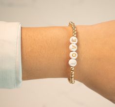 These word bracelets are ultra customizable. They feature painted resin letters on a gold-filled stretch bracelet. Choose your letter colorway, and create any name or word you could imagine! Our stretch gold-filled bracelets are made with love in New York City. They are made with high-quality gold-filled beads that do not tarnish or turn colo The lettering on our resin beads is painted on and may fade with time. Avoid excessive contact with water to increase its longevity! Custom sizing is avail Love In New York, Word Bracelets, Resin Letters, Painted Resin, Everyday Bracelet, Word Bracelet, Ball Drop, Ball Bracelet, White Rainbow