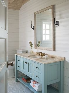 a bathroom with two sinks and a large mirror