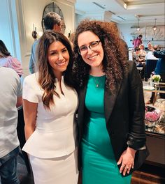 two women standing next to each other smiling