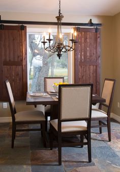 a dining room table with chairs and a chandelier