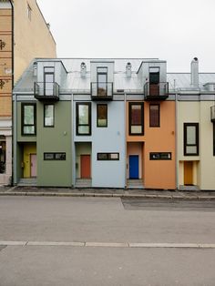 several multi - colored buildings with balconies and windows