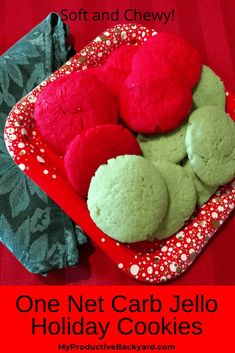 some red and green cookies are in a red tray on a table with the words, one net carb jello holiday cookies