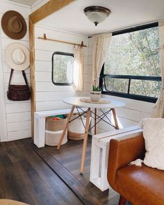 the interior of a tiny home with wood floors and white walls, including a window