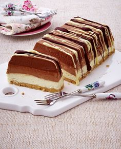 a piece of cake sitting on top of a white plate next to a knife and fork