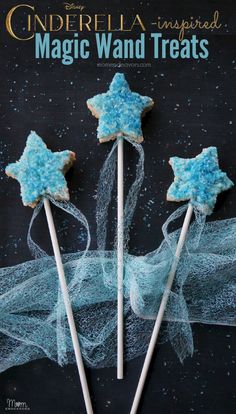 some cookies are on sticks with blue icing and sprinkles in the shape of stars