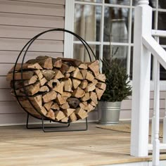 a stack of firewood sitting on top of a wooden porch