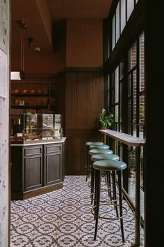 several stools are lined up in front of the bar