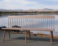 a wooden bench sitting in front of a body of water