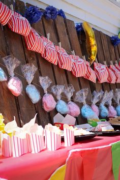 there are many candy bags hanging on the wall next to each other with ribbons and streamers