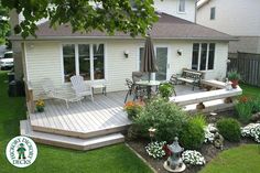 a deck with chairs and tables in the grass