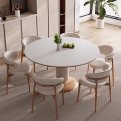 a white table with six chairs and a plant in the center is surrounded by other furniture