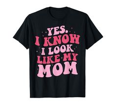 a black shirt with pink lettering that says yes i know i look like my mom