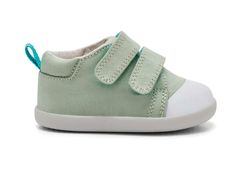 a baby's green and white sneaker with two straps on the side,