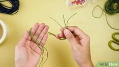 someone is working on some type of craft project with yarn and scissors in their hands