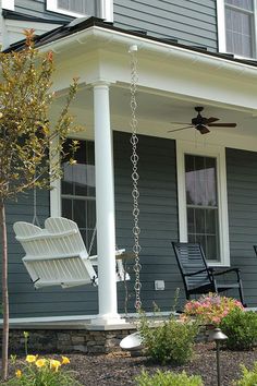 a porch swing is hanging from the side of a house