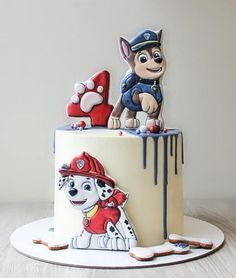 there is a cake that looks like a fireman and his dog on the top