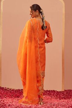 Tangerine orange kurta with tilla, patra, foil mirror embroidery in floral pattern. Paired with floral hand block print salwar and dupatta.
Components: 3
Pattern: Embroidery, Hand Block Printed
Type Of Work: Tilla, patra, foil mirror, floral
Neckline: Notched
Sleeve Type: Three quarter
Fabric: Kurta: Silk Chanderi, Salwar: Bamberg Satin, Dupatta: Silk Organza
Color: Orange
Other Details: 
Scallop bordered sheer dupatta
Lace embroidered cutwork hem
Occasion: Sangeet - Aza Fashions Dupatta Lace, Blouse Yoke, Mirror Embroidery, Personal Shopping Service, Embroidery Hand, Tangerine Orange, Organza Dupatta, Silk Organza, Cut Work