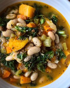 a white bowl filled with beans and vegetables