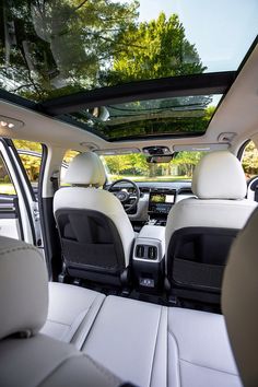 the interior of a car with its sunroof and passenger seats folded down on both sides