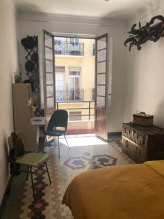 a bedroom with a bed, chair and sliding glass door