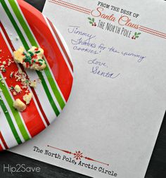 a plate with some food on it next to a paper that says santa clause the north pole