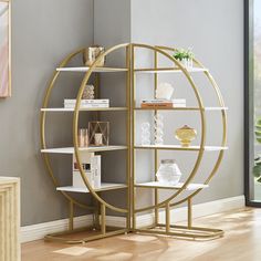 a white and gold book shelf with books on it