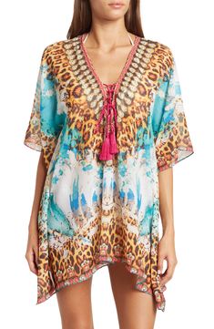 Unleash your boho spirit in this lace-up cover-up kimono styled with vivid allover patterns. 33'' length (O/S) Lace-up closure V-neck Kimono sleeves 100% polyester Dry clean Imported Model stats: 5'10", 32" bust, 25" waist, 36" hip. Model is wearing size OS. Bohemian Multicolor Tassel Cover-up, Multicolor Vacation Kaftan With Tassels, Bohemian V-neck Cover-up With Tropical Print, Bohemian V-neck Tropical Print Cover-up, Multicolor Tasseled Kaftan For Vacation, Multicolor Tassel Kaftan For Vacation, Festival Boho Print Beachwear Cover-up, Bohemian Multicolor Tunic Cover-up, Bohemian Multicolor Printed Cover-up