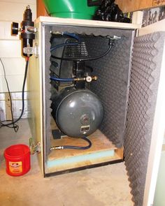 an open storage cabinet with a propane tank in it