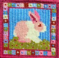 a close up of a cross stitch pattern with a rabbit on it's face