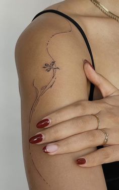 a woman's arm with a flower tattoo on the left side of her body