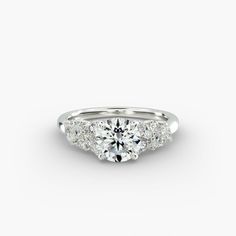 a three stone engagement ring with diamonds on the side