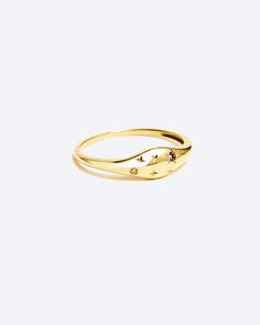 a gold ring with two small diamonds on it