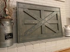 two metal buckets are sitting on the mantle