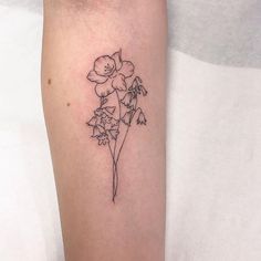 a single flower tattoo on the left arm