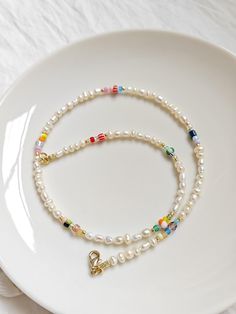 ✋100% HANDMADE 🍹 Cute beads and tiny freshwater pearl necklace, Perfect for summer surf / beach / layered necklace. 📏SIZE: 41cm long / 16.1 inch * If you need other lengths, please contact me or leave a message in the order. 📿 MATERIAL: 3-4mm freshwater pearls 2-6mm glass beads 18K Gold plated clasp 📦 Packaging: 🔆 All comes in a beautifully packaged cotton pouch ready to be gifted. * If you have any ideas about packaging, please feel free to contact me. ✈️ Shipping and Delivery: 🔆 I fully understand your concerns about international shipping, so I improve the logistics experience in every link: * All items ship within 1-2 business days (3-4 days for custom orders). * All orders have tracking so you can monitor the delivery process. * It takes about 8-10 business days to arrive in mos Dainty Pearl Necklace With Colorful Beads, Summer Pearl Necklaces With Tiny Beads, Summer Pearl Necklace With Tiny Beads, Dainty Pearl Necklace For Summer Gift, Dainty Pearl Necklace Gift, Dainty Pearl Necklace As Summer Gift, Dainty Pearl Necklace For Summer, Dainty Summer Pearl Necklace Gift, Summer Pearl Necklace With Tiny Beads For Gift