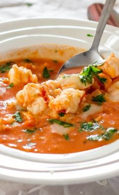 a bowl of soup with shrimp and tomato sauce