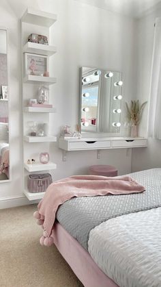 a bedroom with a bed, mirror and shelves on the wall above it that are white