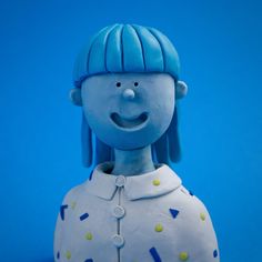 a blue and white ceramic figurine with a smile on it's face