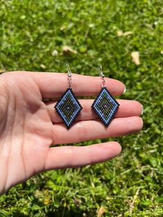 A Staple design in my shop! From the April Collection - 🌎  This pair of hand beaded earrings was made with an Earthy color pallet using blue, green, black and bronze beads.  This pattern is a signature design in my shop - the perfect size for humans who don't want to wear large jewelry. My inspiration came from the land and sea, the forest and water, and the stars mixed in the dark nighttime sky.  These earrings are so comfortable to wear - lightweight and easy to wear. 💧All findings are silver plated and nickel free. 🤍Made with love using size 11/0 beads.  Earrings are 2.25" long including the ear hooks. Hand Beaded Earrings, Nighttime Sky, Earrings Patterns, Land And Sea, Beaded Earrings Patterns, Beads Earrings, Large Jewelry, Earring Patterns, Earthy Colors