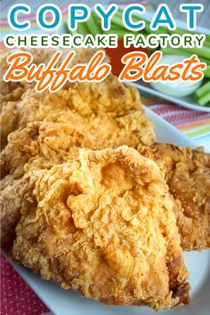 two fried chicken patties on a plate with the words copycat cheesecake factory buffalo blast