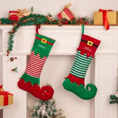 christmas stockings hanging on the fireplace with presents