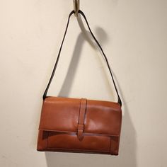 Brown Leather Bag With A Small Light Stain Shown In Pick Never Worn Everyday Brown Flap Bag With Hasp Closure, Brown Flap Bag With Hasp Closure For Everyday Use, Brown Leather Flap Bag With Hasp Closure, Tan Flap Bag For Everyday Use, Brown Shoulder Bag With Hasp Closure For Everyday Use, Tan Flap Bag With Removable Pouch For Everyday Use, Vintage Flap Shoulder Bag For Everyday, Everyday Tan Flap Bag With Removable Pouch, Tan Shoulder Flap Bag For Daily Use