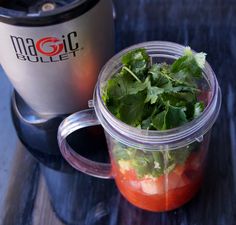 a blender filled with fresh vegetables sitting on top of a counter