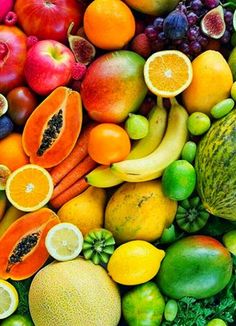 many different types of fruits and vegetables are arranged in the shape of a rainbow color scheme