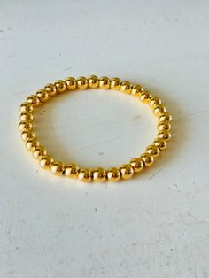 Add some trendy bling to your wrist with our Halo 6mm Gold Bracelet. This stretch bracelet features gleaming gold plated 6mm beads that are sure to catch the eye. Elevate any outfit with this stylish and versatile accessory. Sold individually Gold Plated Stainless Steel 6mm bead bracelet Stretch bracelets fit most Price is for one but shown as examples of sets Adjustable Gold Stretch Bracelet Stackable, Adjustable Stackable Gold Stretch Bracelet, Gold Stackable Stretch Bangle Bracelet, Gold Flexible Stretch Bracelet, Stackable, Flexible Gold Stackable Stretch Bracelet, Flexible Gold Stretch Bracelet Stackable, Everyday Gold Stretch Bangle Bracelet, Gold Bangle Stretch Bracelet, Adjustable Hypoallergenic Gold Stretch Bracelet