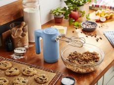 cookies are being made on a table with baking utensils and other kitchen items