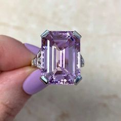 This breathtaking ring has approximately 20.82 carats of emerald-cut Kunzite in a prong setting, complementary by old European cut diamonds and French cut natural rubies on the sides. The rings are meticulously crafted in platinum and 18k yellow gold, featuring intricate milgrain detailing and an openwork under-gallery. The central stone measures around 17.77mm x 19,90mm. ✦GEMSTONE SPECIFICATIONS:  Center Stone: Kunzite  Kunzite Weight: Approx 20.82 Carats  Kunzite Cut Cut: Emerald Cut  Diamond Formal Kunzite Ring With Prong Setting, Delulu Era, Estate Diamond Jewelry, Diamond Ring Set, French Cut, Diamond Ring Settings, Citrine Ring, 18k Yellow Gold Ring, European Cut Diamonds