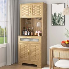 a wooden cabinet sitting next to a window filled with bottles and fruit on top of a table